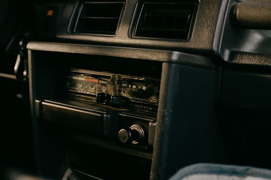 An older car stereo head unit with physical buttons