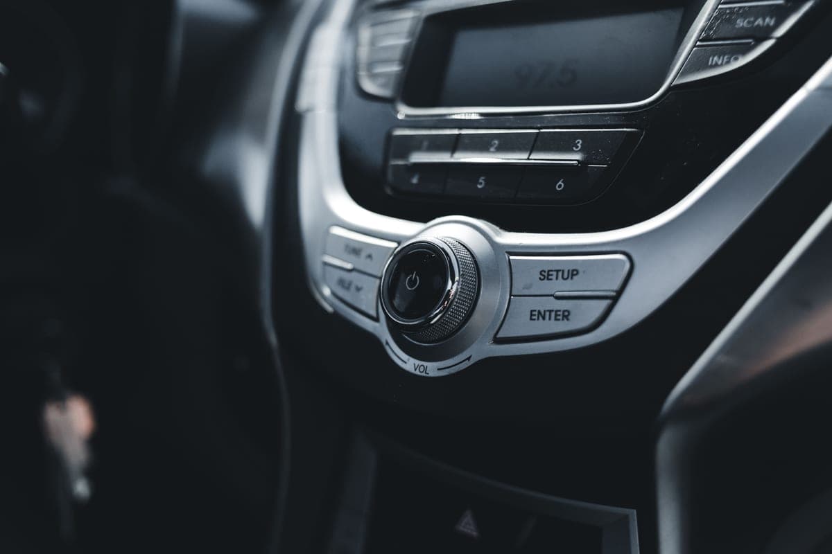 The controls of a car radio on a dashboard