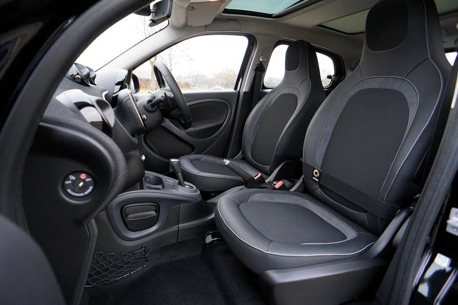 A clean car interior with protective floor mats fitted
