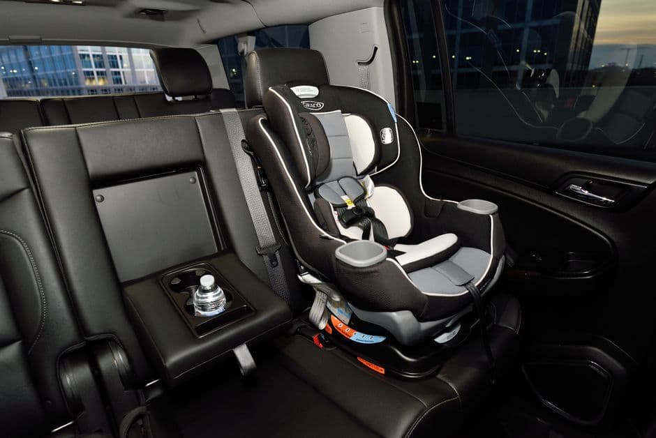 The back seats of a family car with the doors open