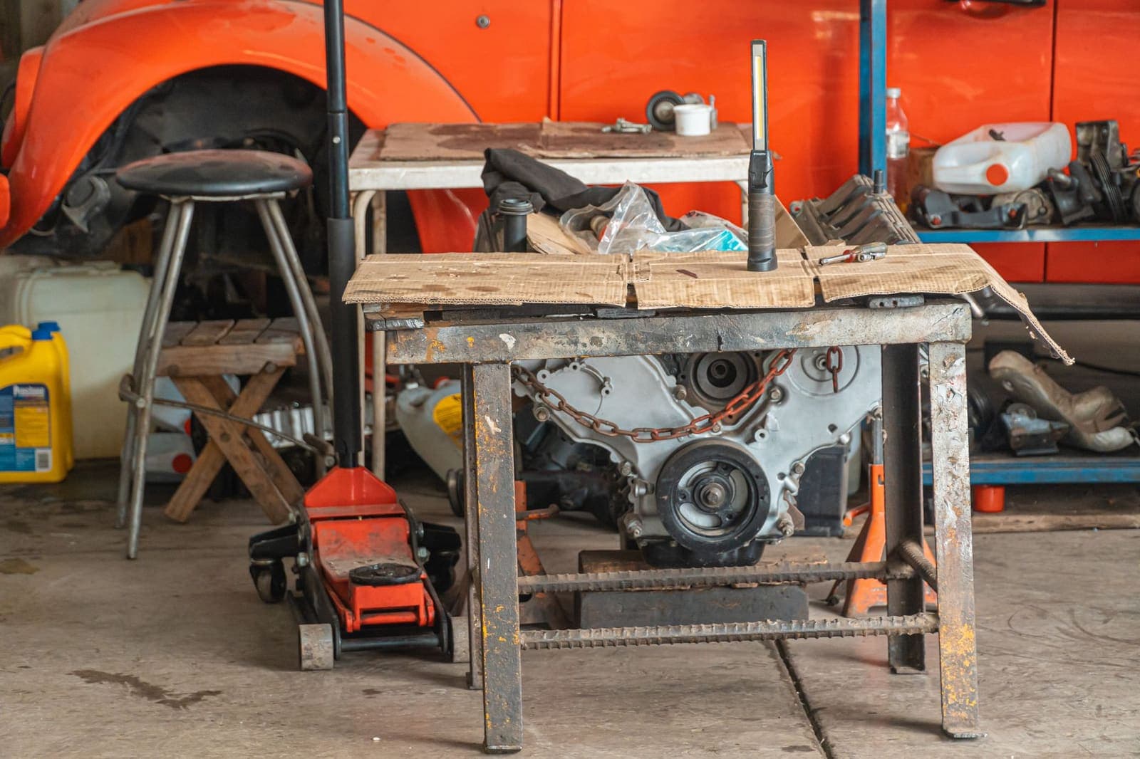 A jump starter, tire inflator and scan tool laid out on a garage workbench