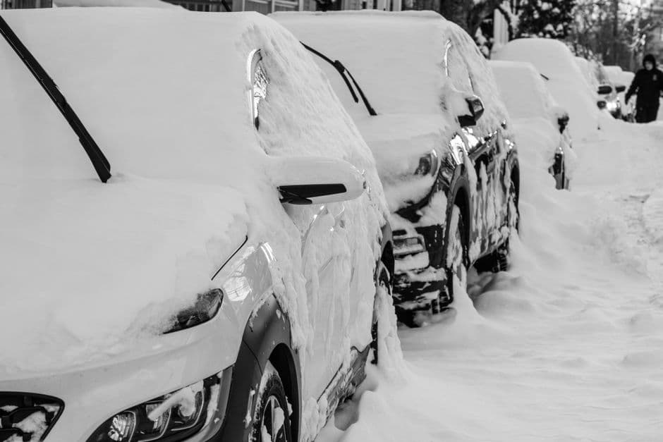 Cars parked on a residential street with frost on the windshields