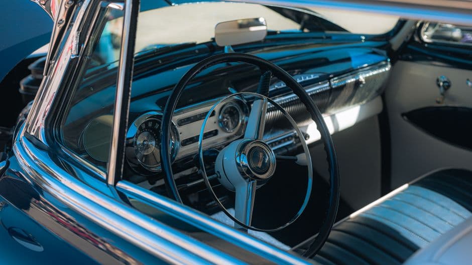 The dashboard and controls of an older car