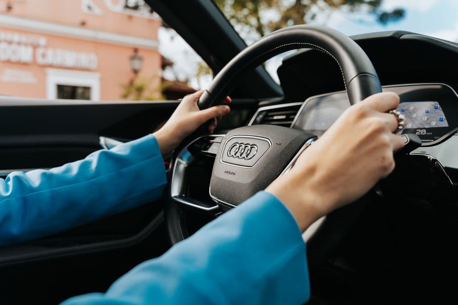 A driver adjusting the seat position in a car