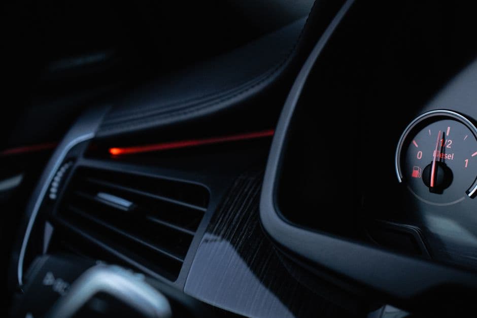A car air vent with the dashboard visible beside it