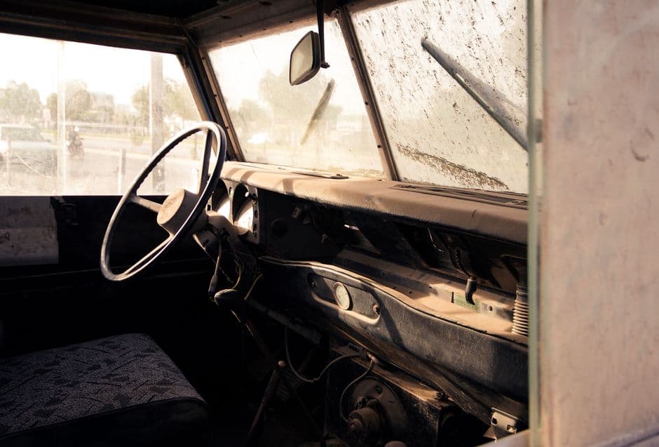 A car interior with sunlight showing dust in the air