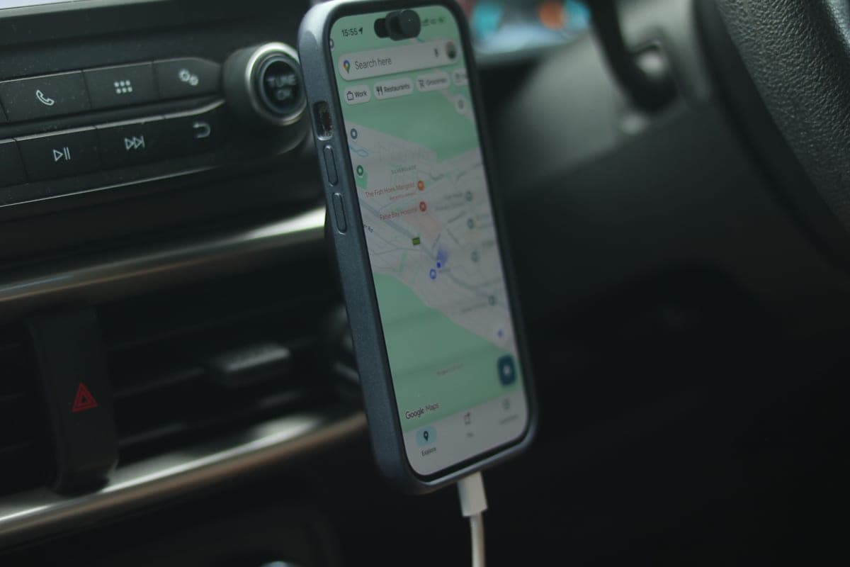 An Android phone charging on a car's center console