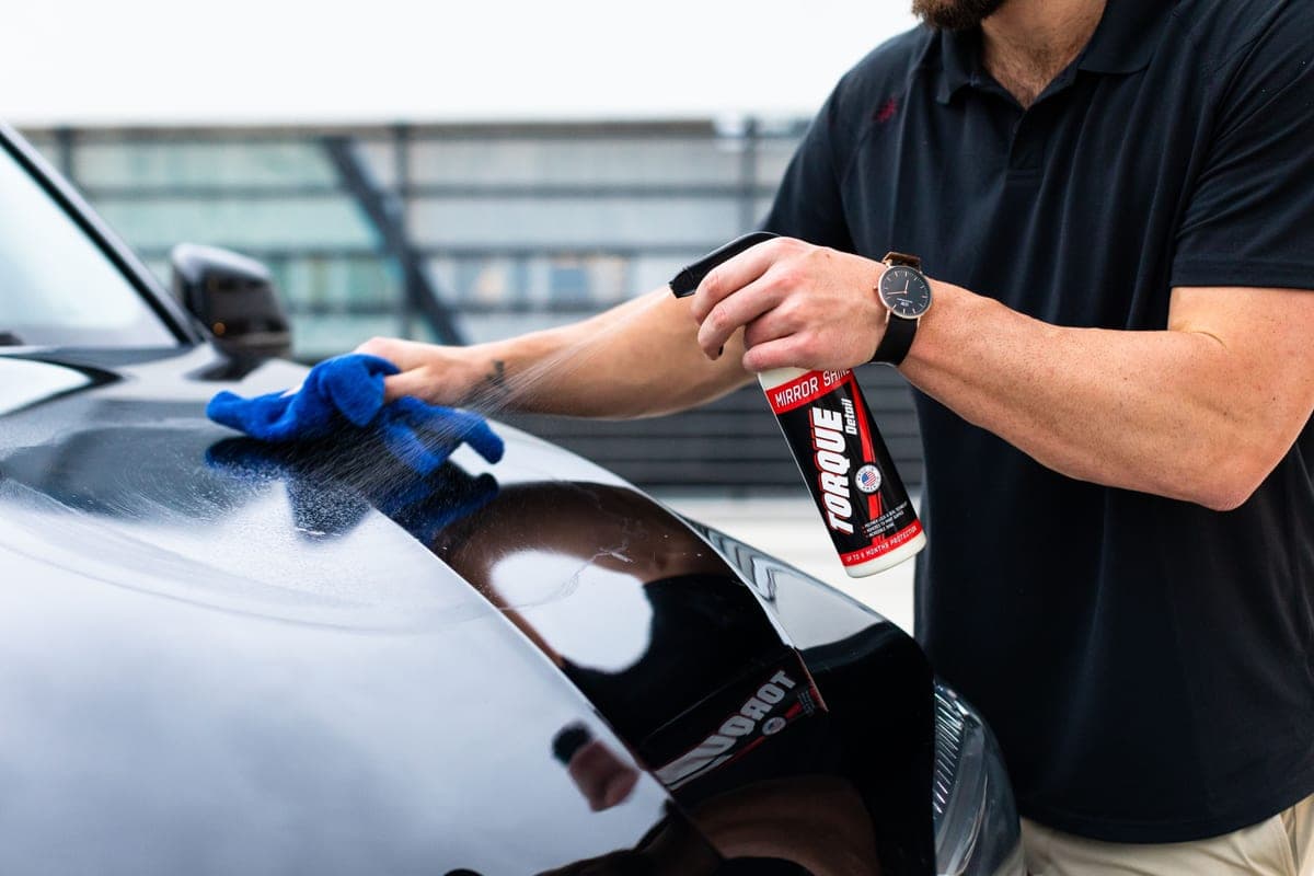 A row of car detailing product bottles on a surface