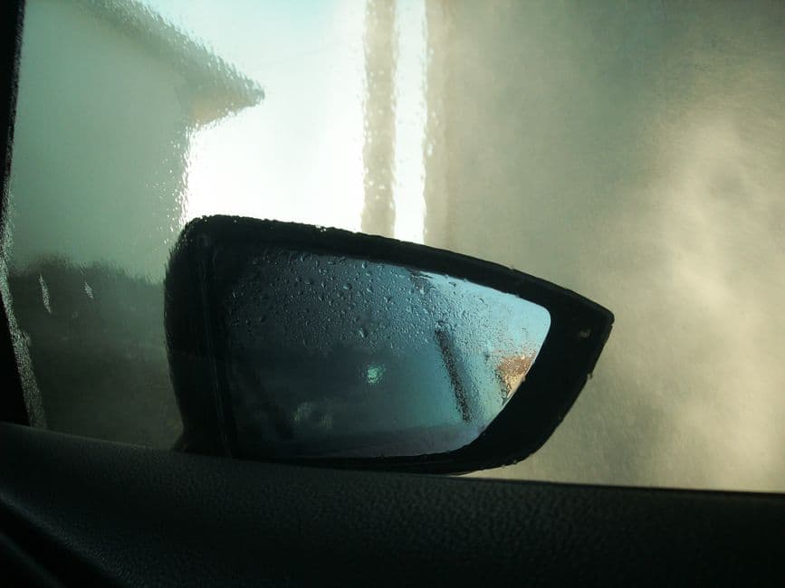 A car door and window photographed from inside the vehicle