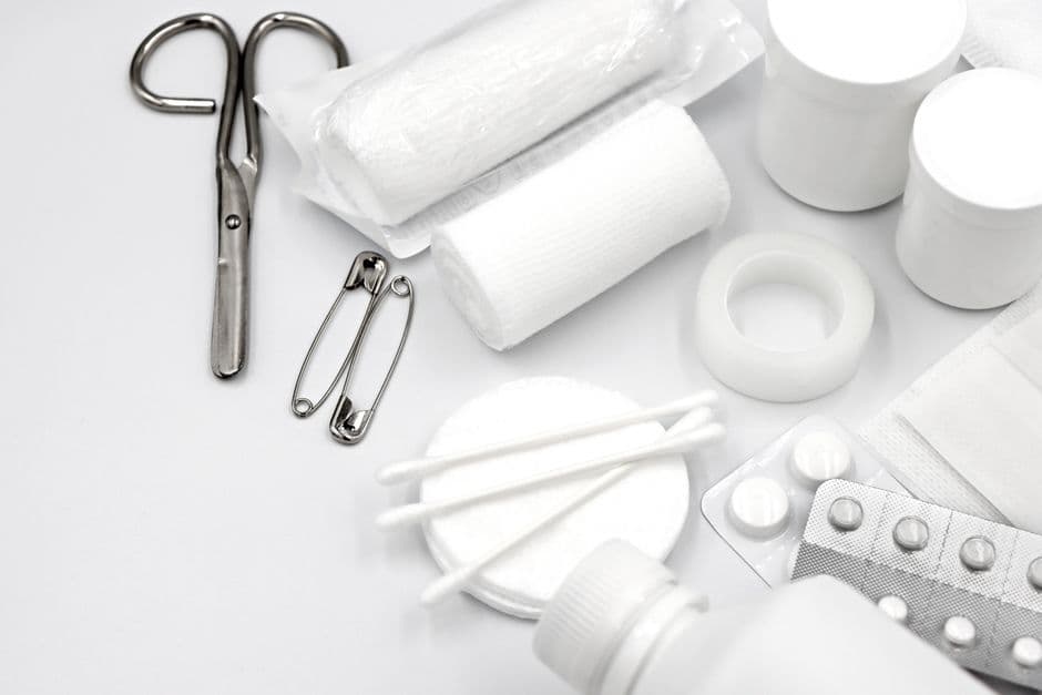 A first aid kit case open on a flat surface