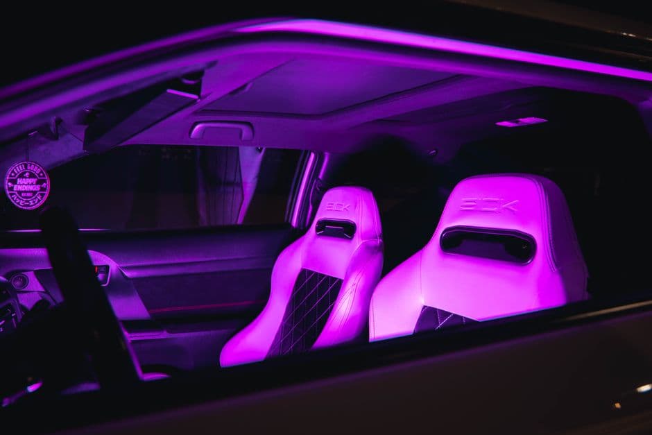Colored LED accent lighting in a car footwell at night