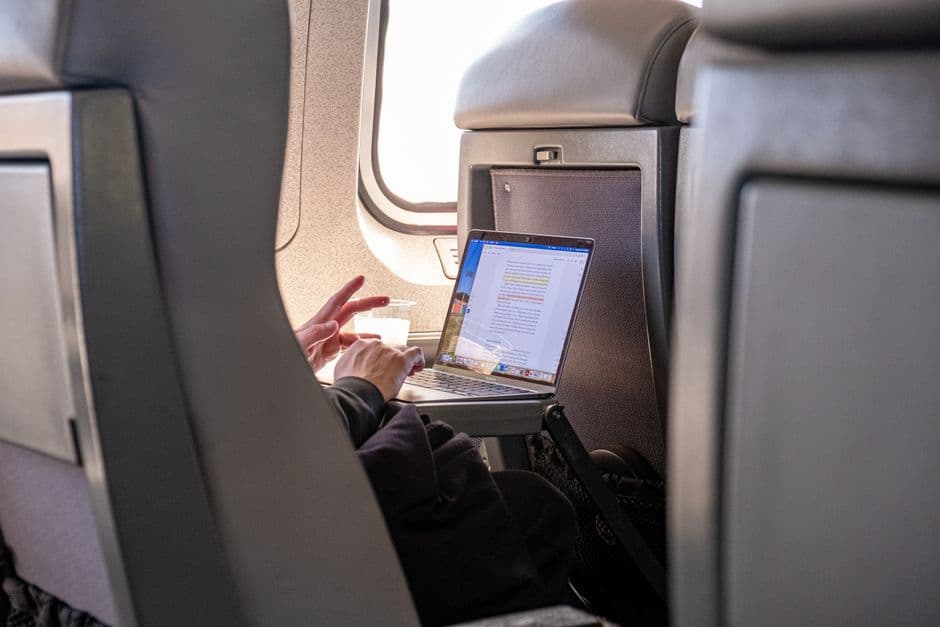 A folding tray table on the back of a car seat