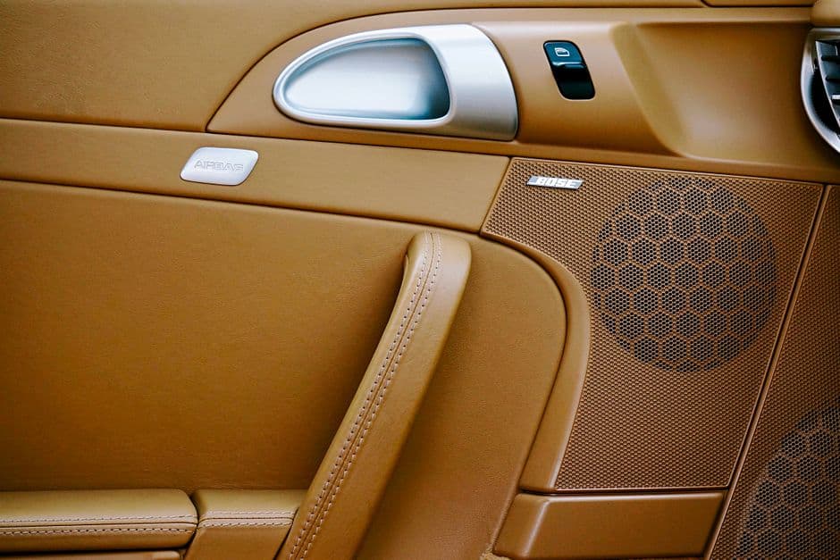 A car door speaker behind its grille