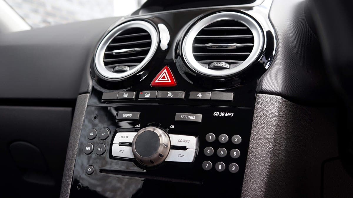 A car stereo head unit with a CD slot in a dashboard