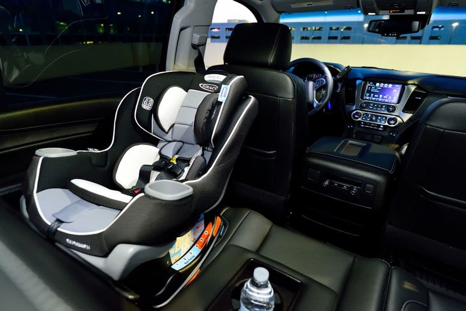 A child car seat installed in the back of a car