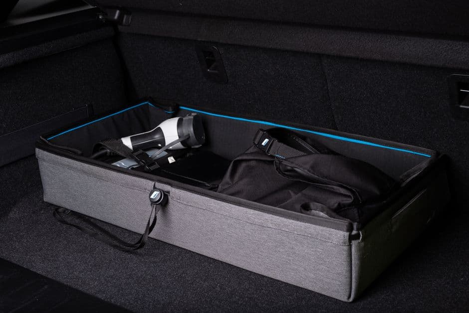 A folding storage crate in the trunk of a car