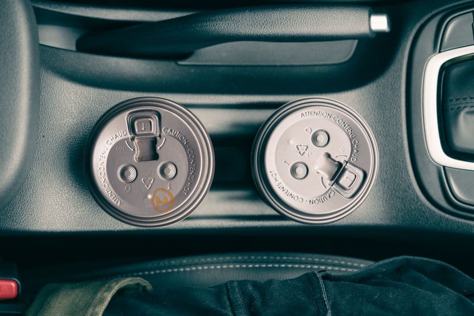 A car center console with cup holders and a gear selector