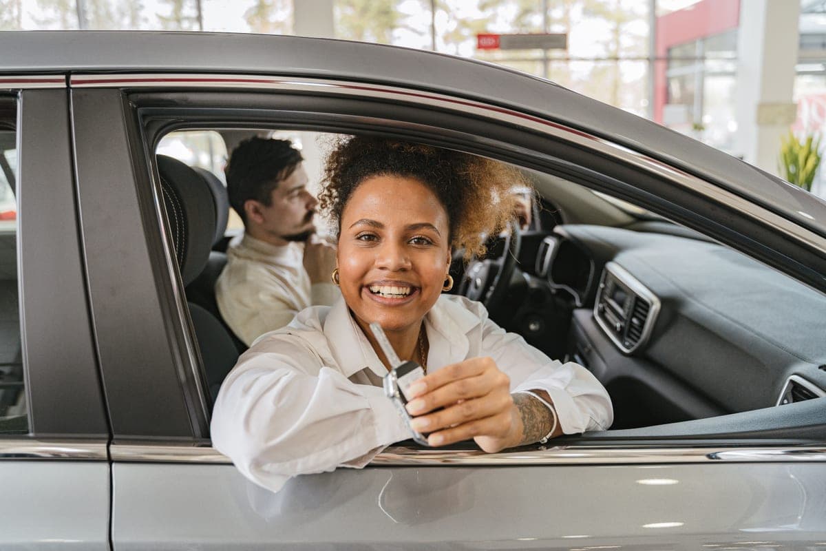 A young person holding a set of car keys