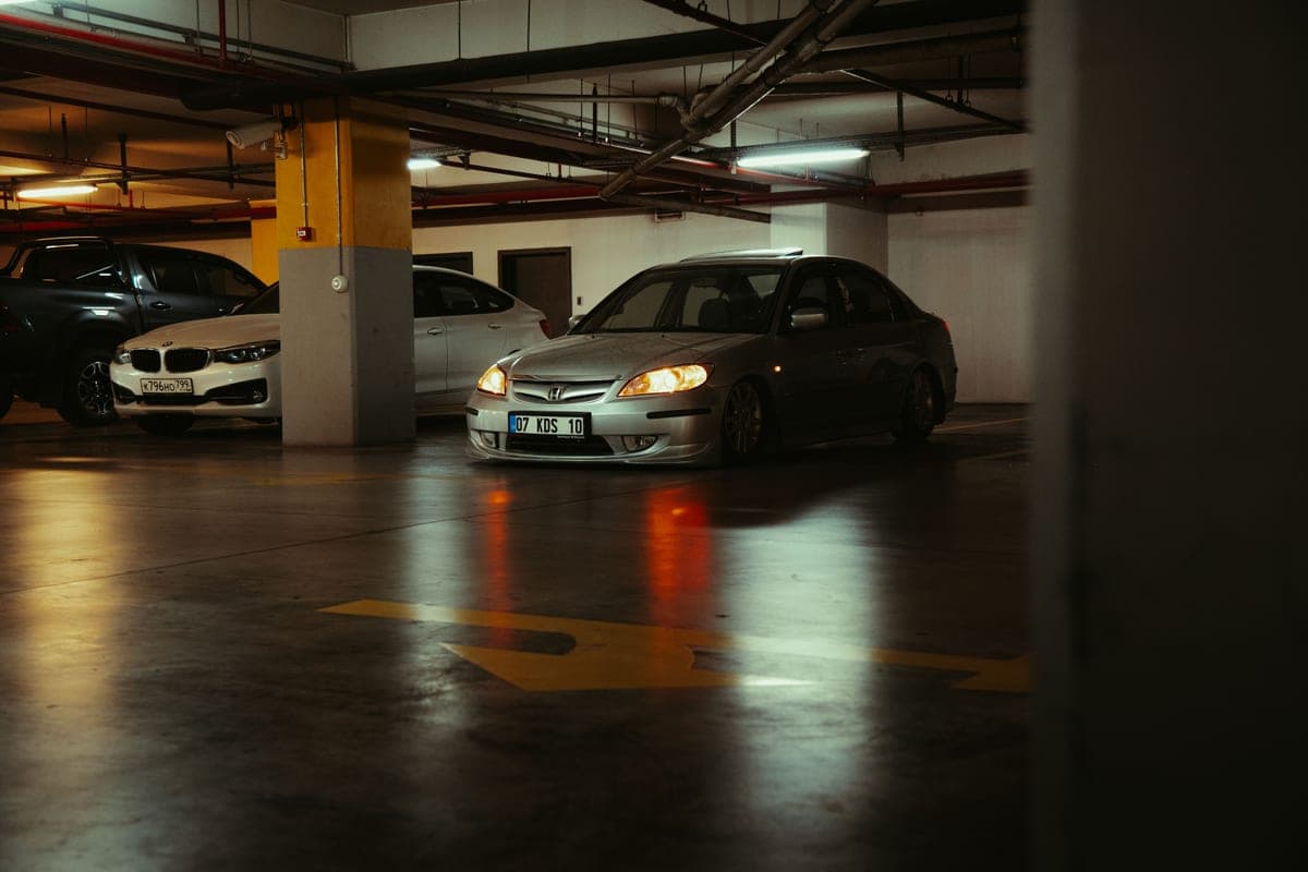 Cars parked in rows inside a concrete multi-storey parking garage