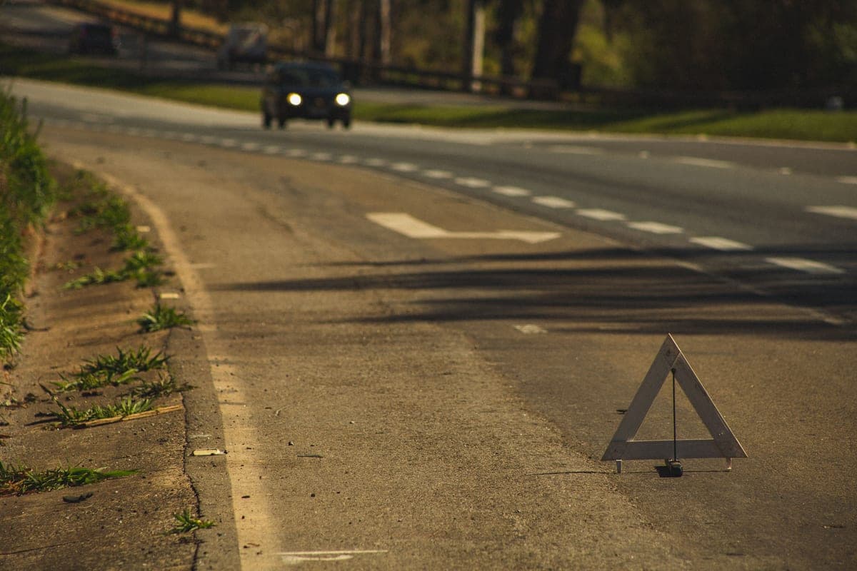 A reflective warning triangle placed on a road