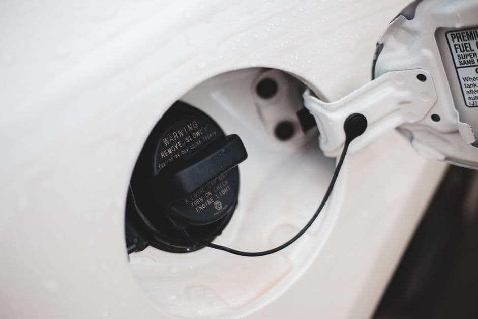 A fuel filler cap open on a car