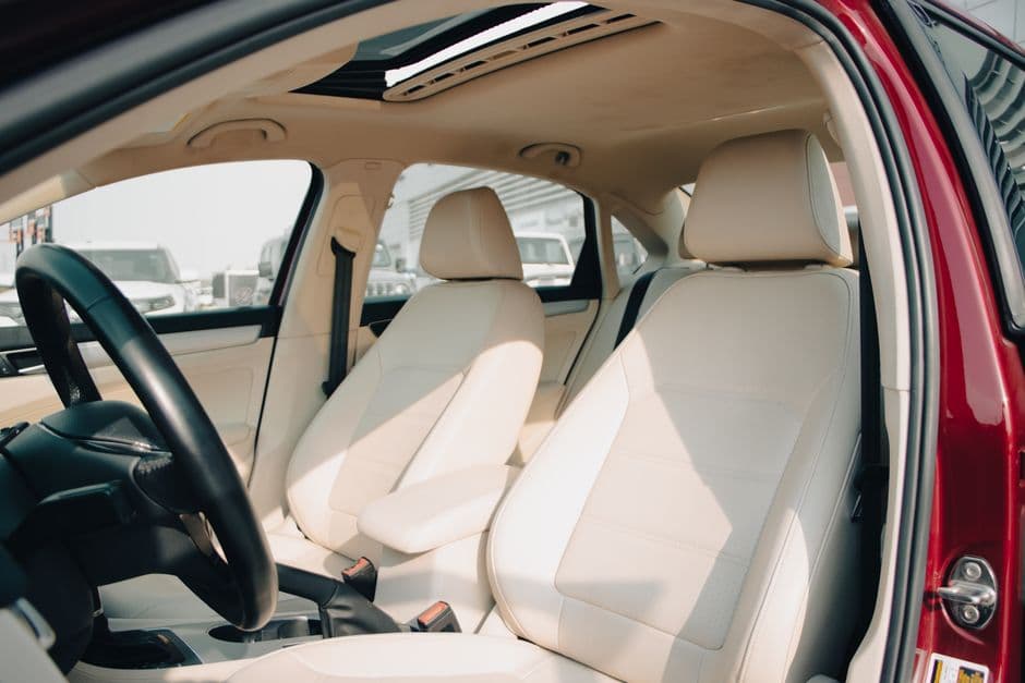 A cushioned seat cover fitted to a car's driver seat