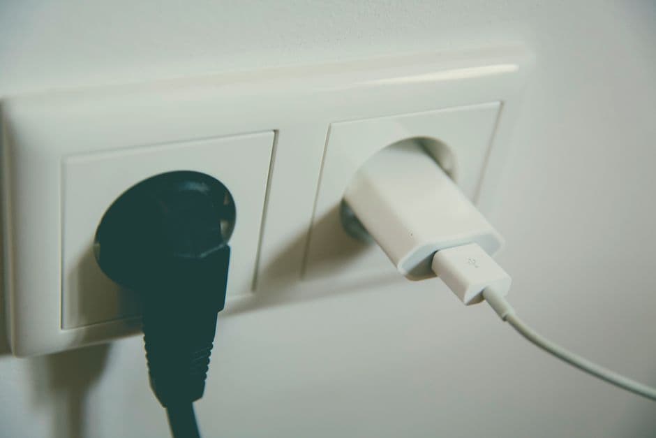A multi-port USB charger plugged into a car socket
