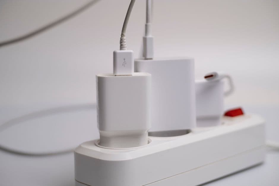 A USB-C charger plugged into a car's 12V socket