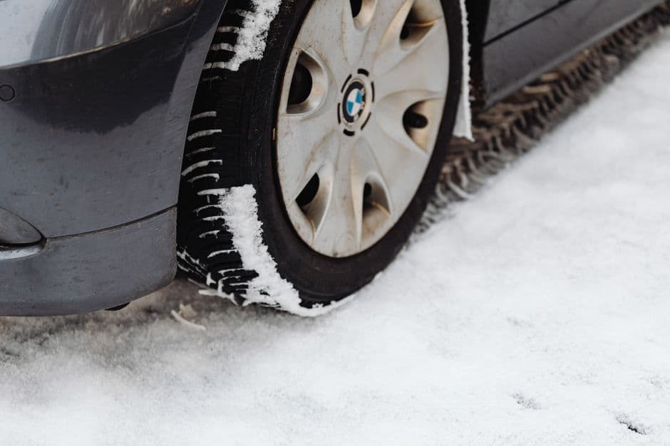 A car tire on a snow-covered road