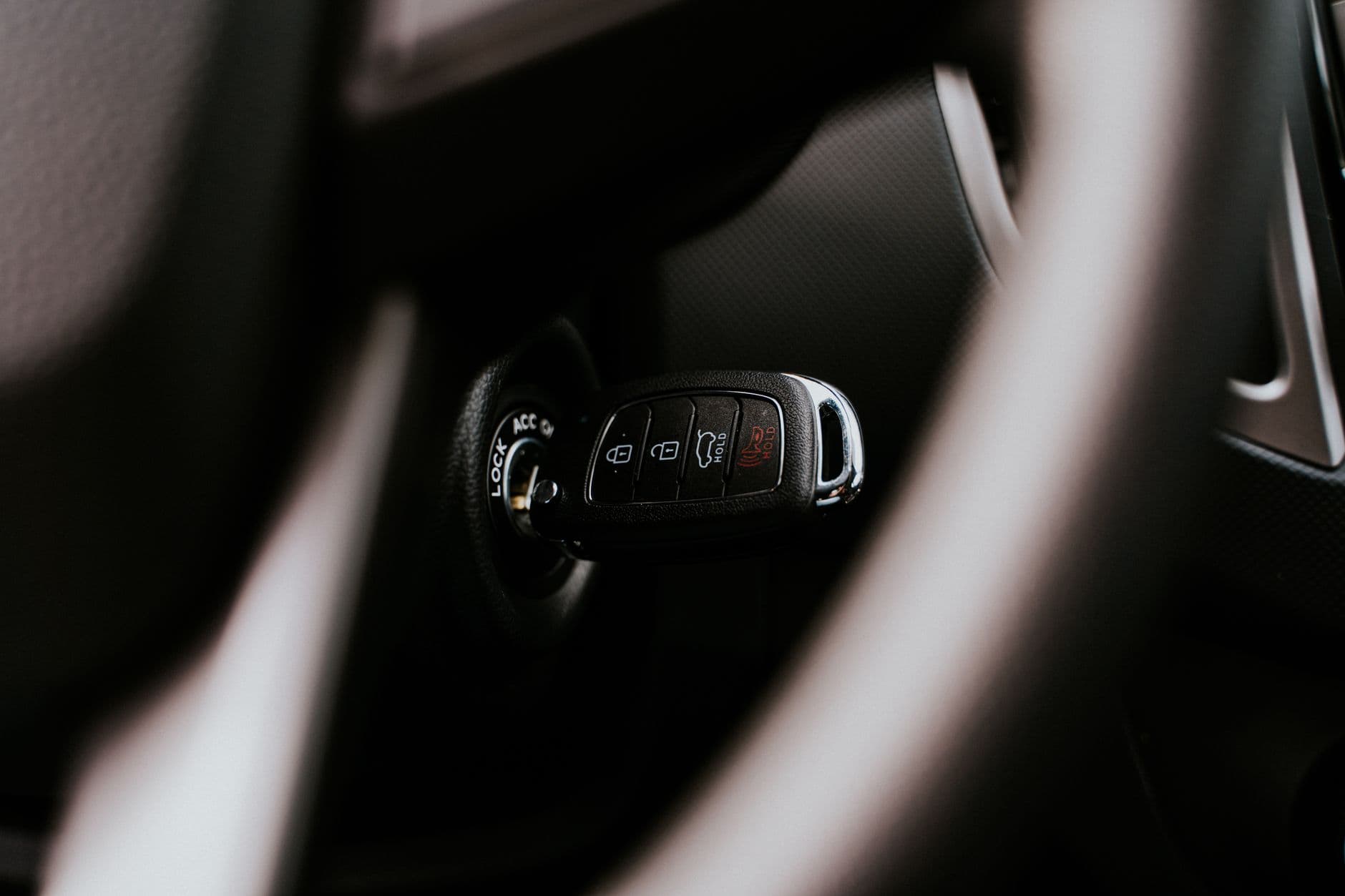 A bright anti-theft bar locked across a car steering wheel