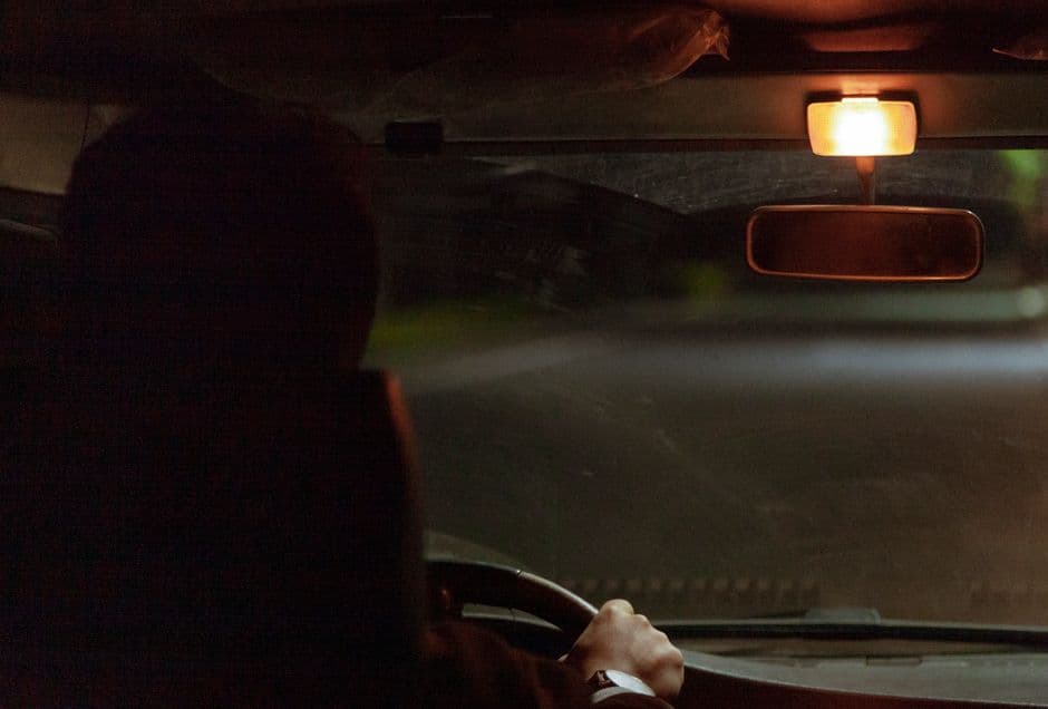 Low sun shining through a car windshield toward the driver