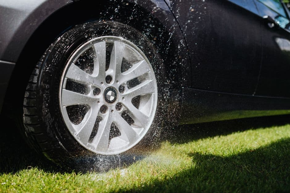 A clean alloy wheel and tire on a parked car