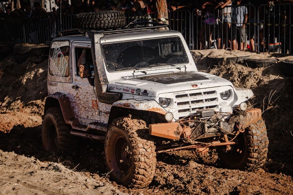A vehicle on a muddy unpaved track