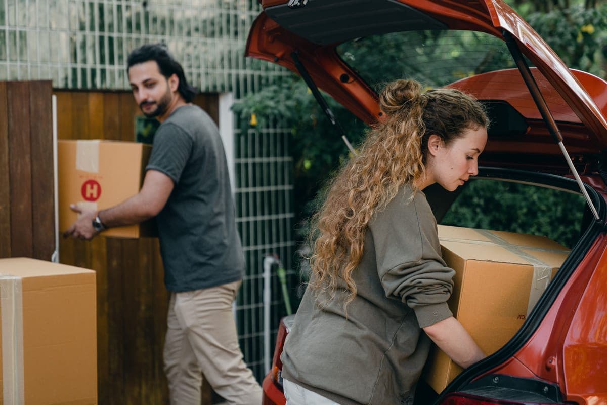 An open car trunk with boxes and bags arranged inside