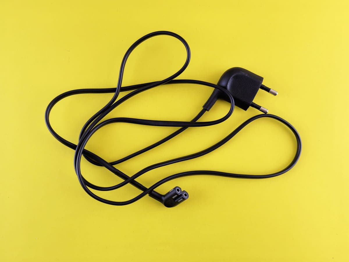 A tangle of charging cables on a flat surface