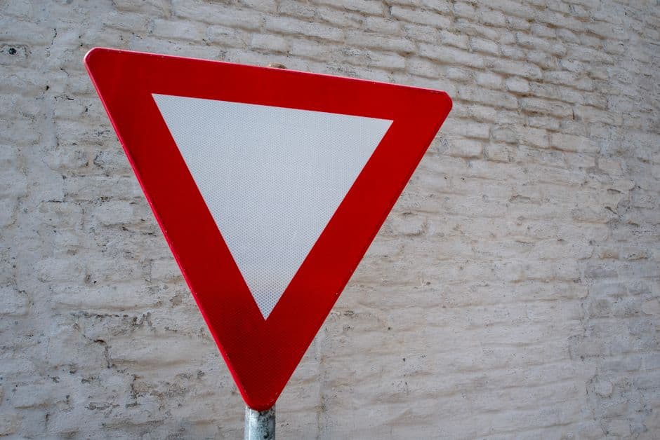 A reflective warning triangle set up on a road shoulder