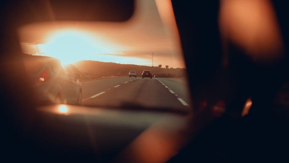 A windshield view of traffic ahead on a multi-lane road
