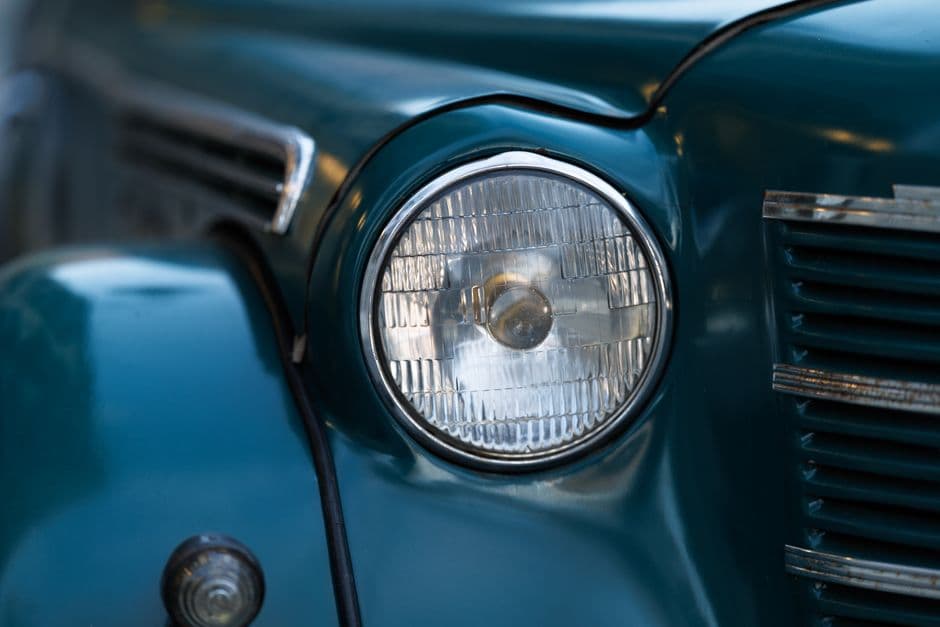 A yellowed and clouded car headlight lens beside a clear one