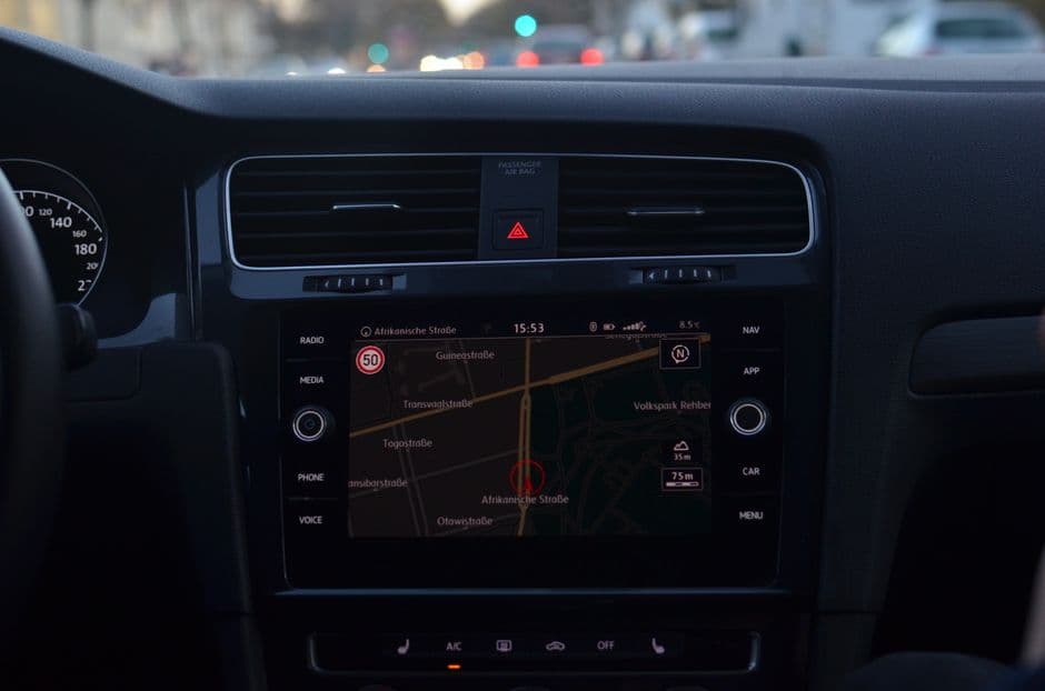 A car dashboard with an aftermarket screen in the center console