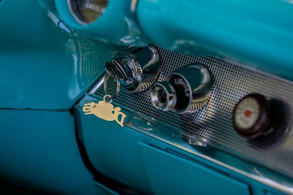 An older car dashboard with a cigarette lighter socket