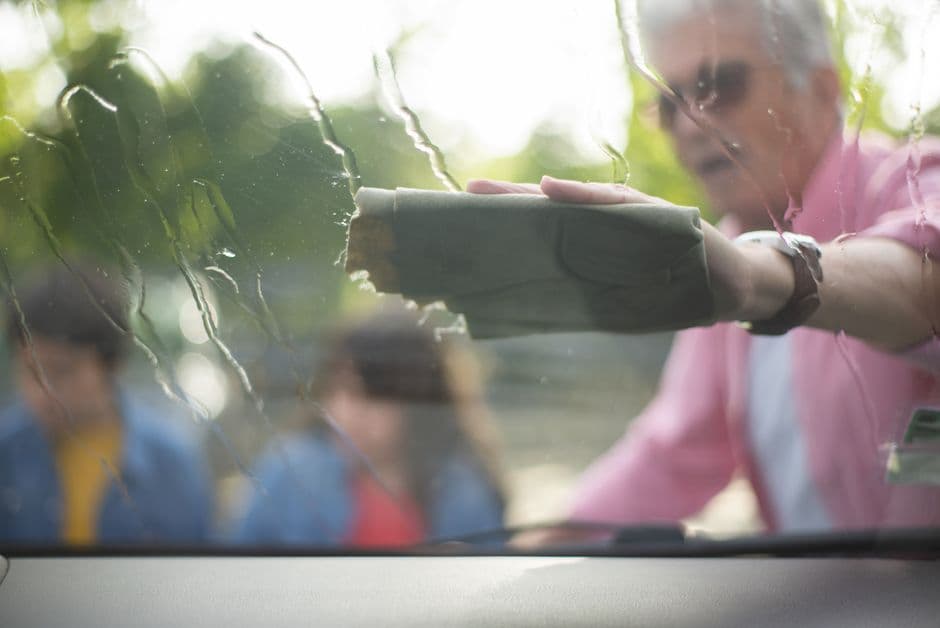A cloth wiping the inside of a car window