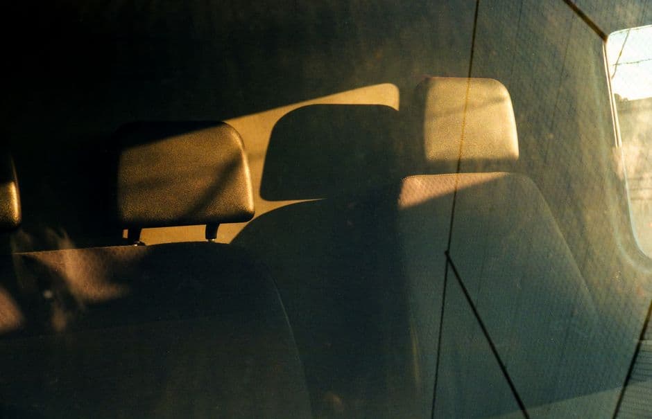 Sunlight falling across a car dashboard and seats