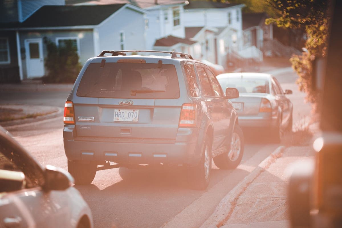 A car parked outdoors in bright summer sunlight