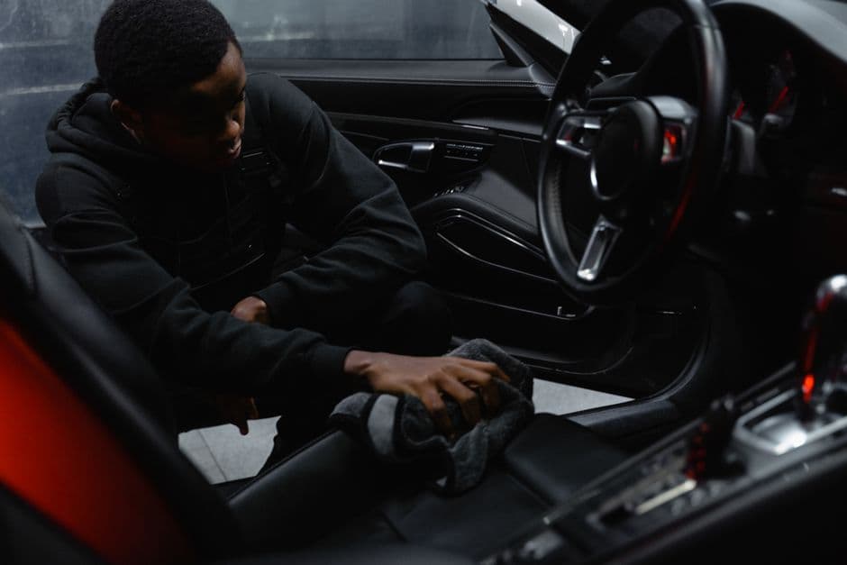 A cloth wiping the bolster of a car seat