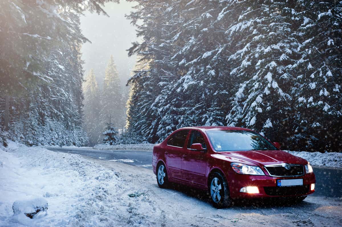 A car parked on a snow-covered road in winter