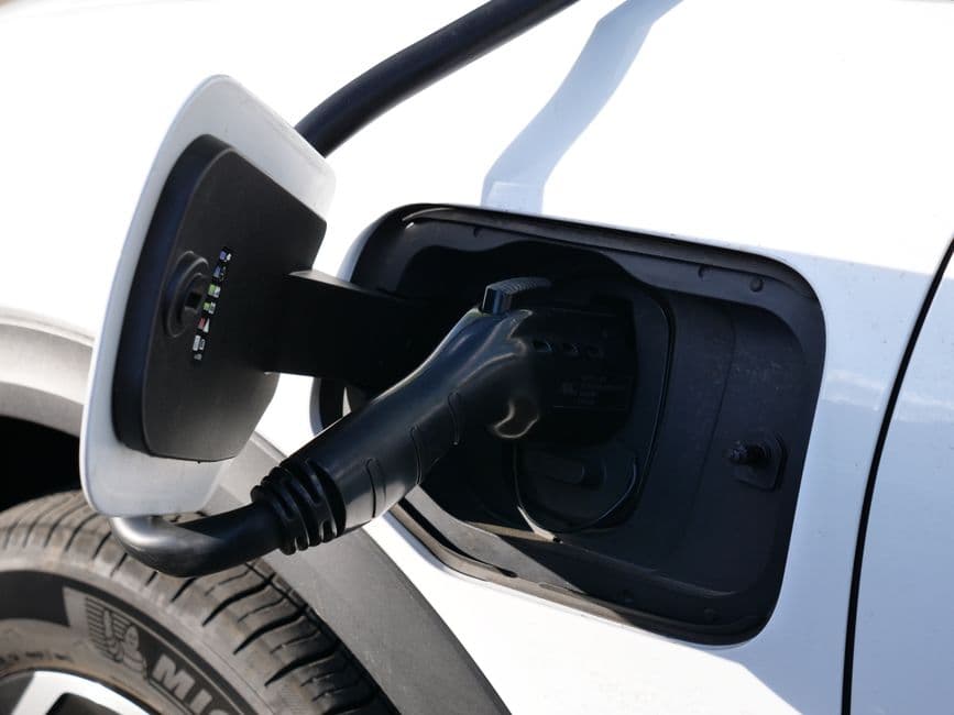 A charging cable plugged into a car's center console