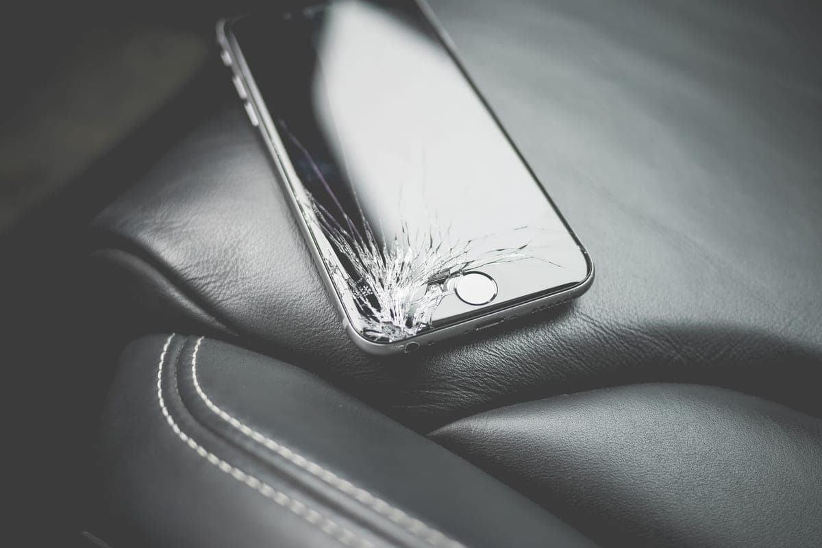 A smartphone lying face down on a car's passenger seat