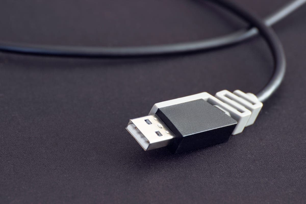 A USB cable plugged into a port in a car center console