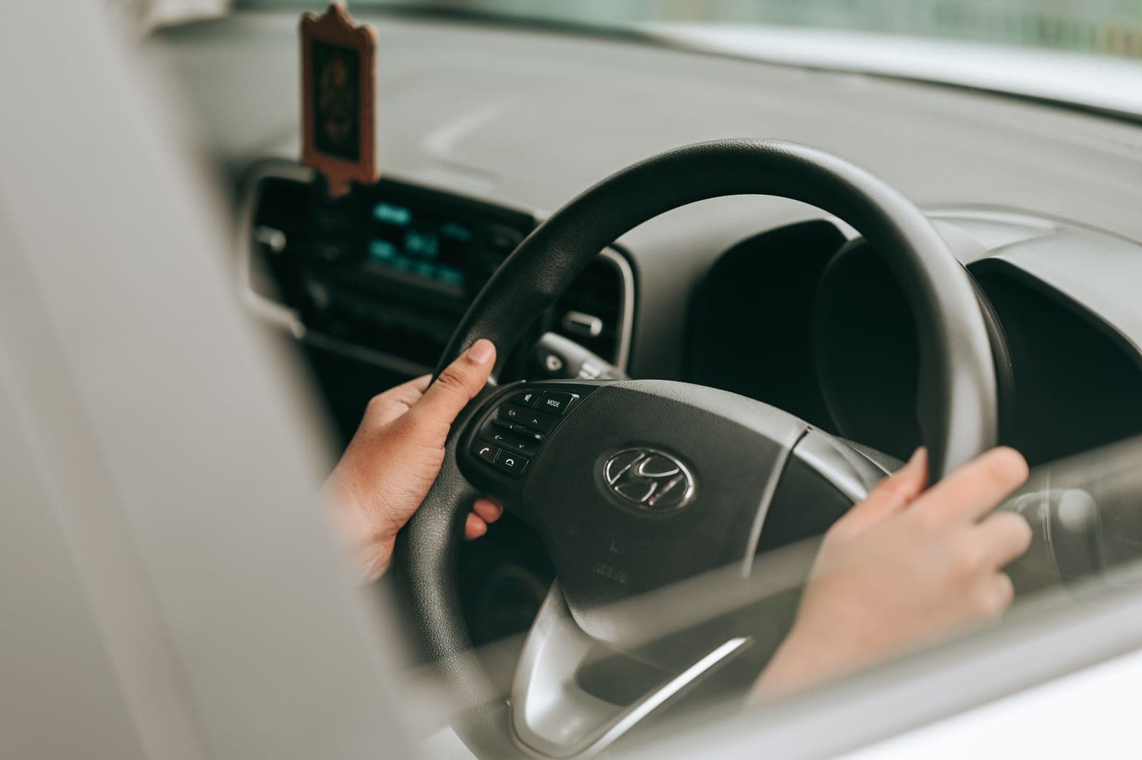 The interior of a car photographed from the passenger side, showing the steering wheel and dashboard