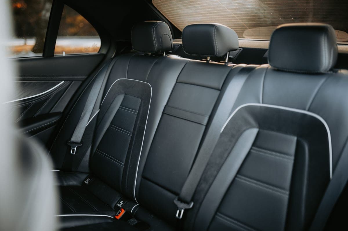 The driver's seat of a car photographed from the passenger side in daylight